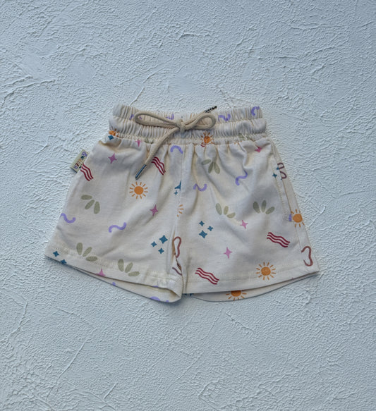Children's shorts with colorful patterns on a light blue background