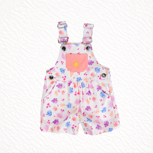 Children's floral overalls with a pink pocket on a white background