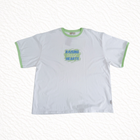 White t-shirt with green text and trim on a white background
