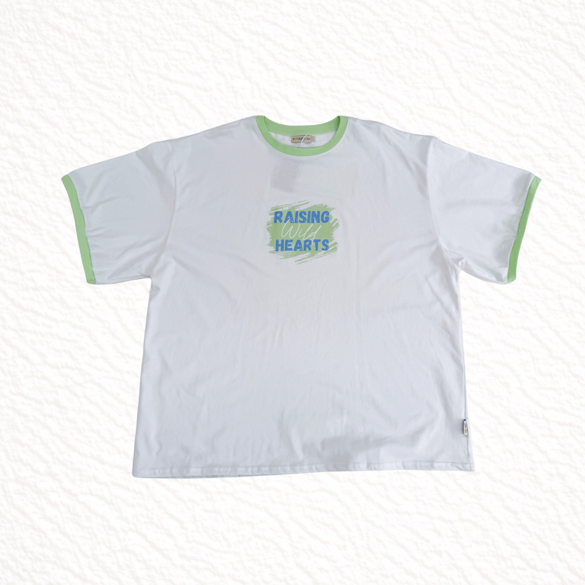 White t-shirt with green text and trim on a white background