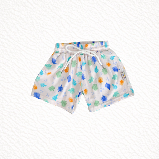 Children's shorts with colorful leaf pattern on a white background