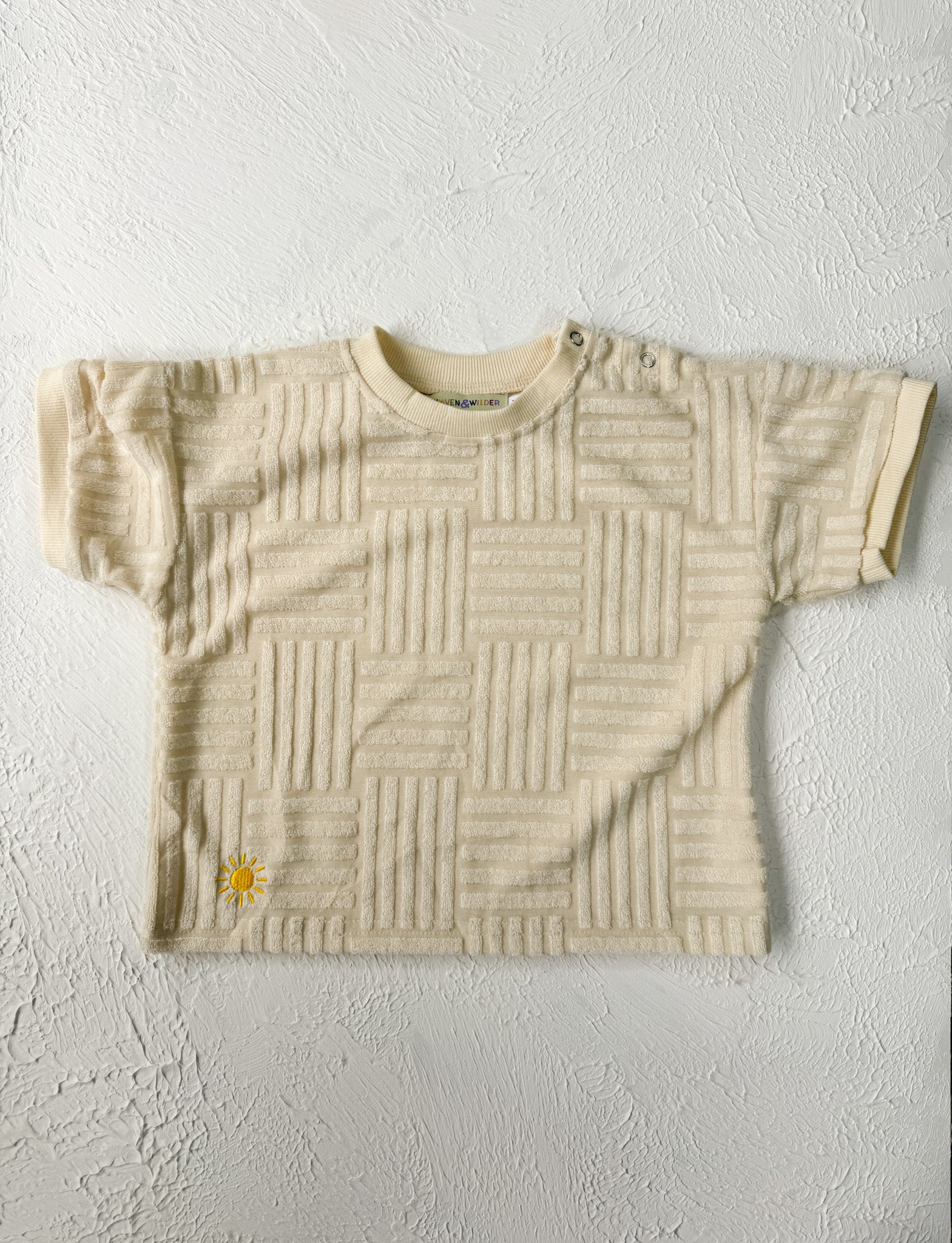 Beige textured t-shirt on a light gray background