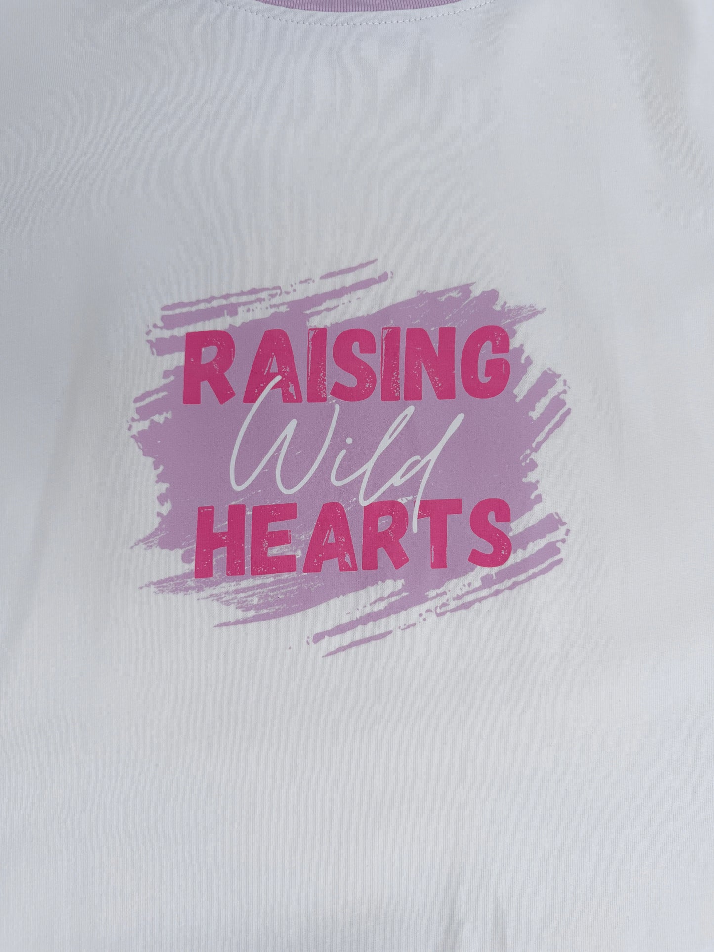 White shirt with 'Raising Wild Hearts' text in pink and purple on a white background