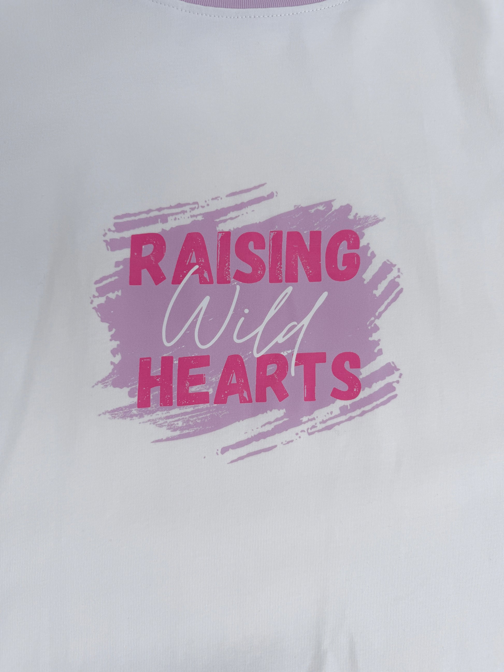 White shirt with 'Raising Wild Hearts' text in pink and purple on a white background