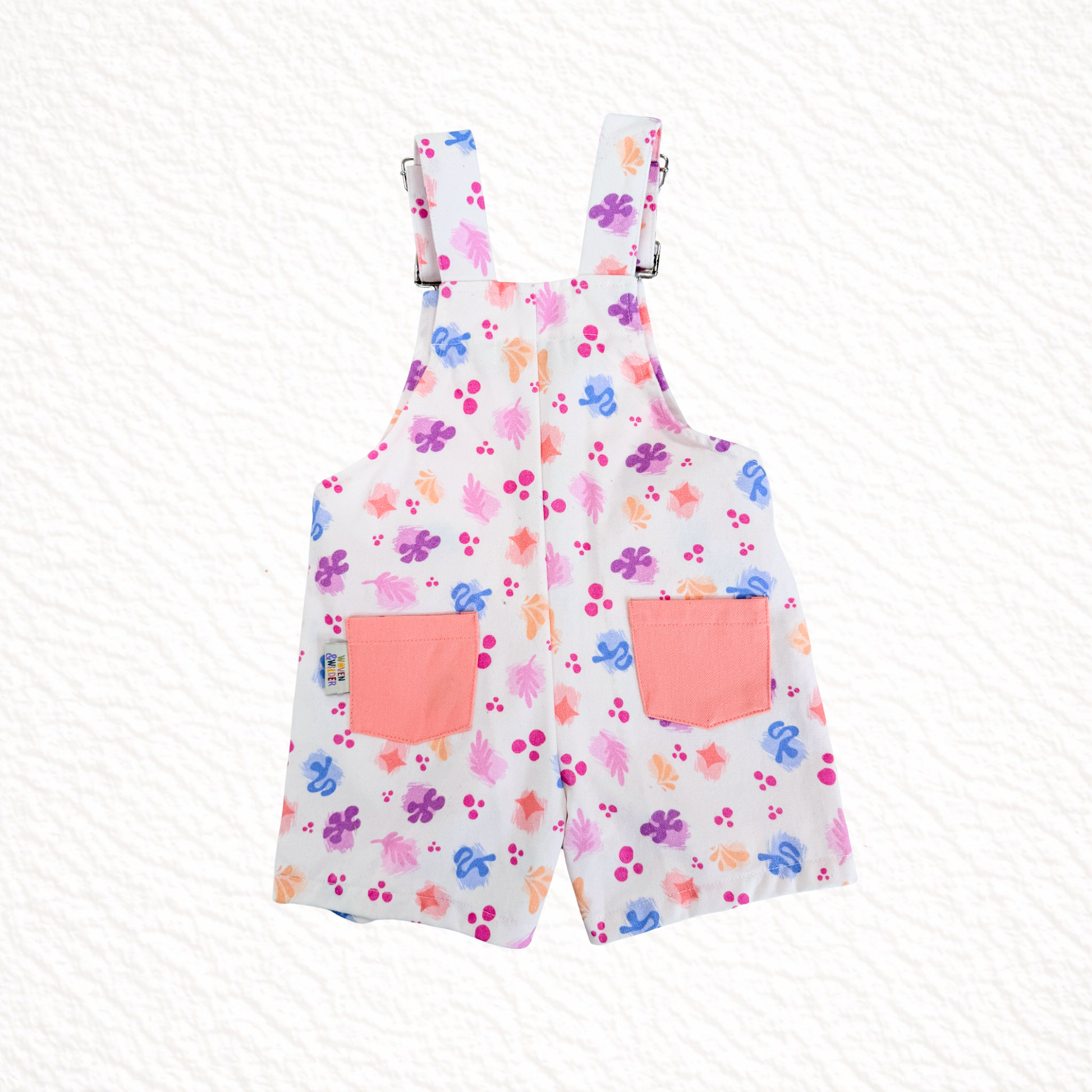 Short overalls with colorful floral pattern on a white background