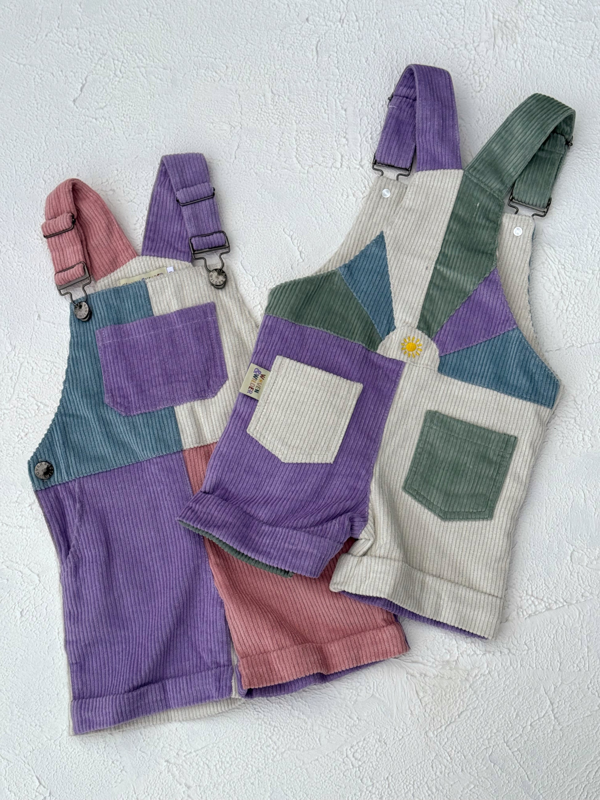 Colorful patchwork overalls on a light gray background